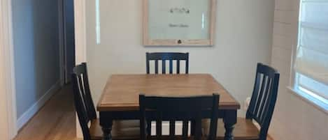 Bright and open dining room with brand new 4 top table.