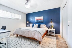 Primary bedroom with king bed and access to shared bathroom