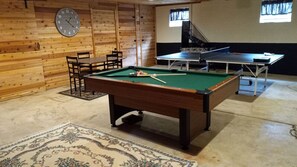 game room in garage with pool table, ping pong.