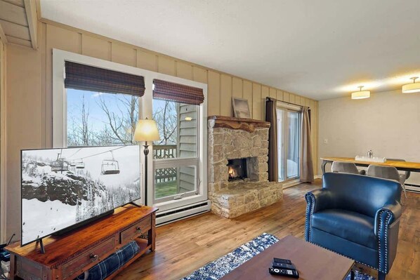 Transform your living area into a haven with three comfortable chairs, a Smart TV, an indoor gas fireplace, access to an outside deck, and a window AC unit