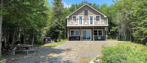 Lake house, front yard and stone path to lake, balcony and patio