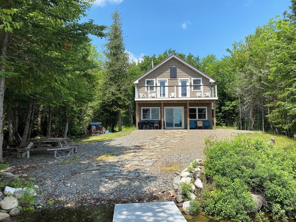 Lake house, front yard and stone path to lake, balcony and patio