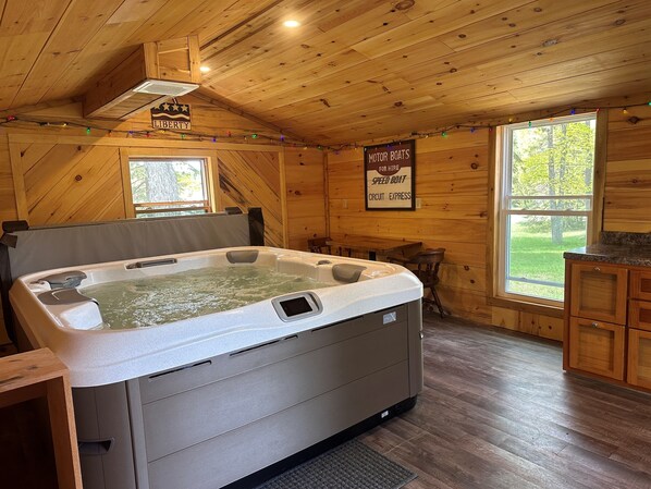 Hot tub in the red out building behind the home that can be enjoyed in all seasons!