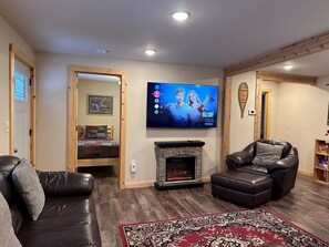 Living Room with 65" TCL Roku TV and fireplace