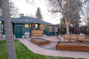 Yard made for entertaining, hot tub, grill and fire pit.
