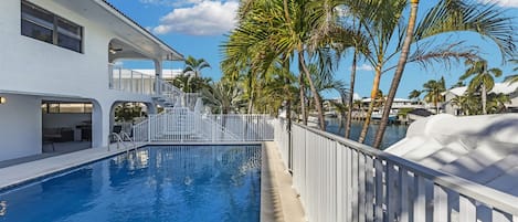 Back view of the home with pool on property shared with duplex neighbor