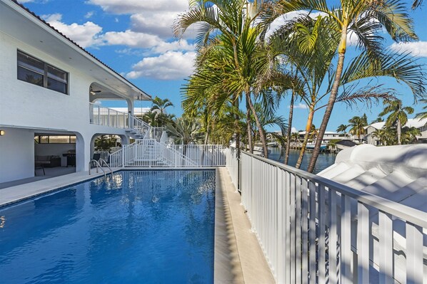 Back view of the home with pool on property shared with duplex neighbor