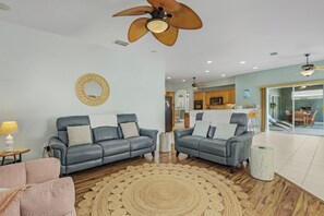 Living room features leather, power reclining sofa and love seat.