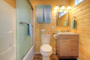 Bathroom with full sized tub and shower combo.