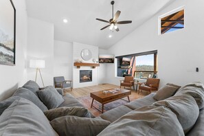 Main level room with fireplace and (out the window) outdoor TV, fireplace