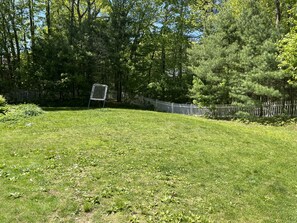Fenced in backyard with deck and 4 burner Weber grill