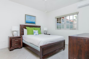 This bedroom has a queen sized bed and is air conditioned.