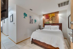 Unwind and recharge in our comfortable sleeping area, featuring a plush bed for a restful night's sleep and a Smart TV for entertainment.