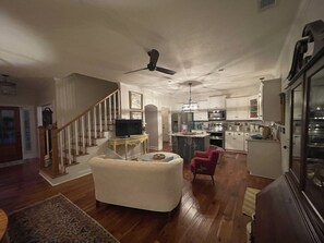 Open floor plan: kitchen and den area with door leading to screen porch
