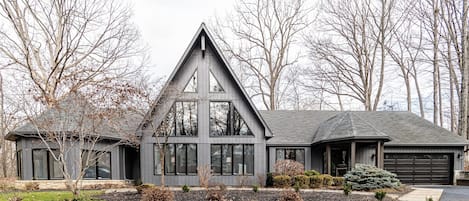 Beautiful exterior featuring a large A-frame style wall of windows.