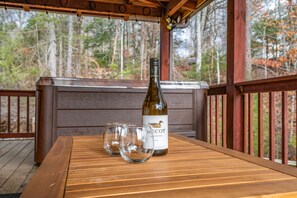 Perfect day to unwind and enjoy a glass of wine by the hot tub 