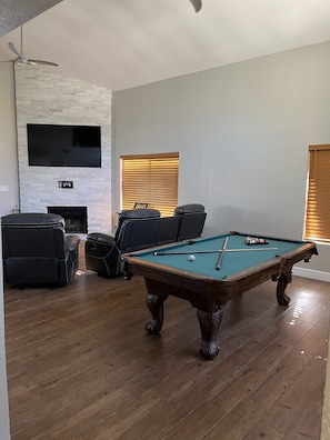 Pool table and large 75" flat screen tv connected to playstation 4.