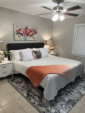 King size bed with a TV in bedroom and walk in closet. 