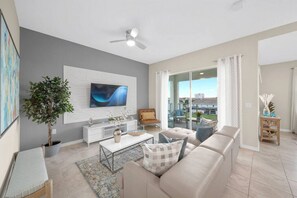 Modern open concept of living room, dining room and kitchen with island!LAKE VIEW & 55" Smart TV!#Disney #Parks #kingdom #springs #StoreyLake #Apartment #Vacation #Rental #waterpark #Kissimmee #Orlando #universal #citywalk