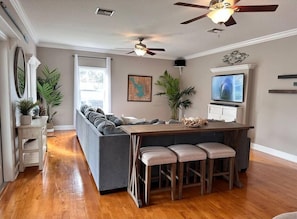 Open living room with large, comfortable sectional and Roku TV.
