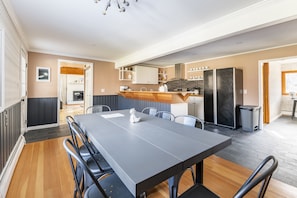 Dining room table in viewing kitchen, living room and office area.