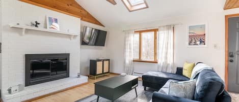 Living room with working fireplace. Relax with friends by a nice fire.