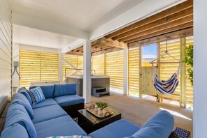 An outdoor oasis for tiki drinks, relaxing in a hammock and hot tub and best of all, an outdoor hot shower for the ultimate beach experience.