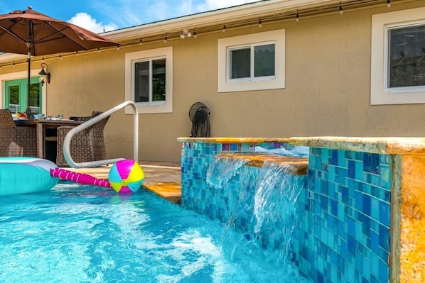 A resort-style oasis in the heart of Deerfield Beach! Large heated saltwater pool with a hot tub, rustic tiki hut with a large gas-powered firepit, string lighting & smart tv. Outdoor dining table for 6 and plenty of seating and lounging for the family.