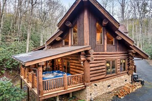 Exterior Retreat: Soak in the hot tub on the deck, surrounded by a serene mountain stream