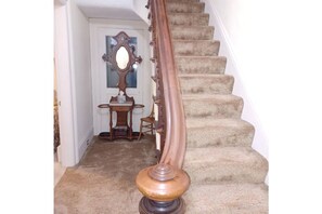 Stairway to three bedrooms and second bathroom upstairs