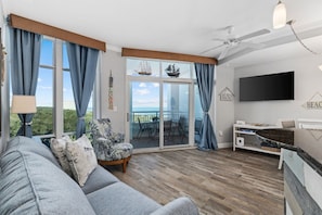 The living room offers a bright and airy space with stunning angled views of the ocean. Unwind on the plush sofa while watching TV, enjoy a game night with your group, or use the open layout for a yoga session as you take in the coastal views.