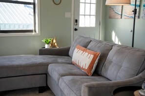 Unwind in the living room’s plush seating, designed for laid-back beach vibes and long conversations.