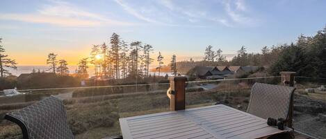 The view! The sun sets over the Salish Sea from natural wood and glass deck.