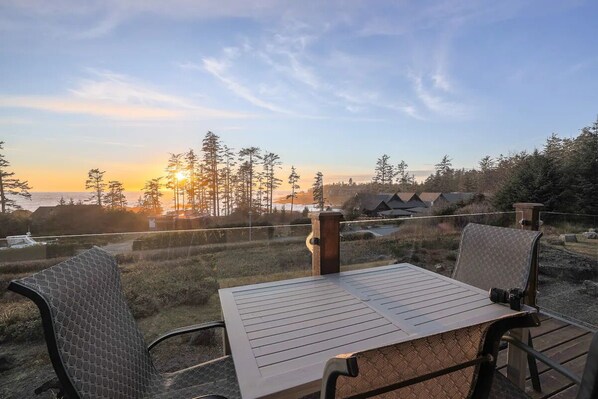The view! The sun sets over the Salish Sea from natural wood and glass deck.