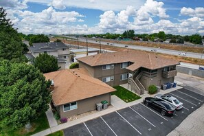 Aerial exterior view with dedicated parking spaces directly in front of the unit