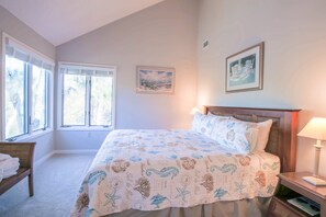 The master suite features a king bed, soaring ceilings and an en suite bathroom.