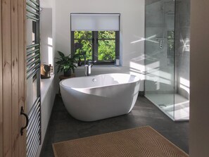 Th large bathroom has a free standing bath with views perfect for stargazing