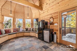 Our airy sunroom with soaring cathedral ceilings and coterie bench seating.