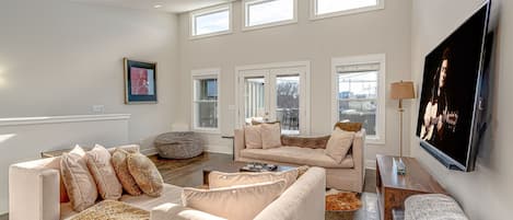 Additional living space with smart TV and kitchenette.