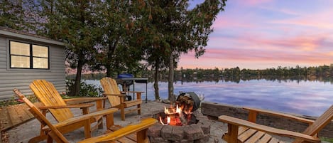 Outdoor seating around the firepit with a great view of the lake