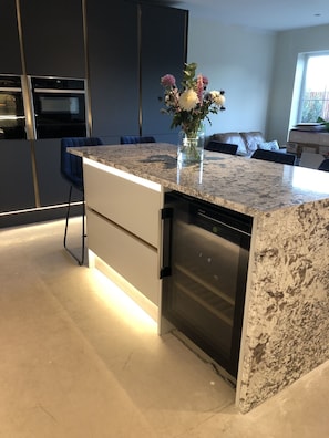 Well arranged kitchen with large fridge, freezer and separate wine fridge. 