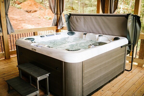 We invite you to relax in the bubbling hot tub on our lower level porch.
