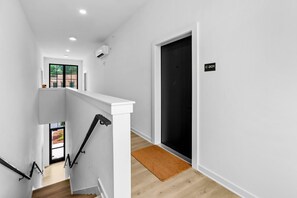 Bright, modern entryway leading to your private retreat. Easy access with secure, well-lit hallways for your comfort and convenience.