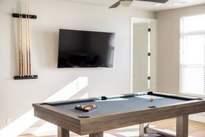 Pool Table upstairs in the main living area as well as a flat screen TV, perfect for watching the game while shooting some pool.