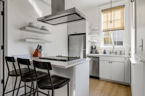 Fully Stocked Kitchen with Island Seating for 3