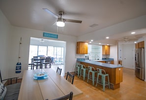 View of the dining area, kitchen, and entertainment room.