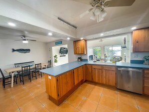 Open concept kitchen and dining area with a view to the lanai and patio!