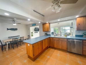 Open concept kitchen and dining area with a view to the lanai and patio!