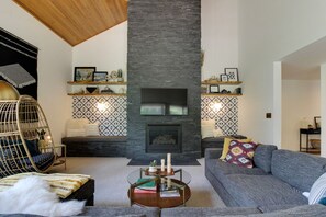 The great room features vaulted ceilings, a gas fireplace and flat screen TV 