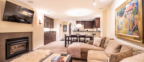 Gas fireplace and large screen TV in the living room area.